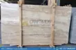 Stacked beige travertine stone slabs