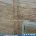 Dark beige Travertine Slabs on display in factory