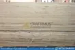 Large, textured silver travertine blocks in factory
