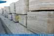 Large, textured Stacked silver travertine blocks in factory