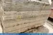 Large, textured silver travertine blocks in factory