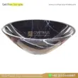 Black marble sink with white veins, perfect for elegant bathroom decor. Durable natural stone design.