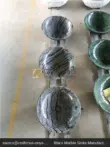 Black and gray marble vessel sink with unique veining patterns.