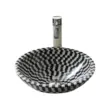 Black and white patterned natural stone vessel sink with chrome faucet.