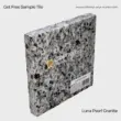 Luna Pearl Granite sample tile in gray with black speckles, showcasing a natural stone finish.