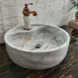 Marble wash basin in white with grey veining, perfect for elegant bathroom decor.