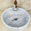 White marble sink with a smooth finish and stylish bronze faucet. Ideal for elegant bathroom designs.
