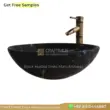 Black marble sink with elegant design and brass faucet, perfect for modern bathrooms.