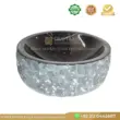 Black onyx sink with a textured gray marble exterior, featuring a smooth, glossy finish.