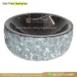 Black and gray marble sink with a polished interior and textured exterior. Perfect for modern bathrooms.