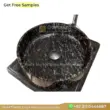 Black marble round sink with unique veining, perfect for luxurious bathroom designs.