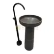 Black marble wash basin with modern faucet stand for bathroom decor.