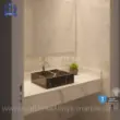 Black marble sink with white veins in modern bathroom setting, featuring elegant countertop and wall tiles.