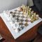 luxury green onyx chess set at a brown wooden table